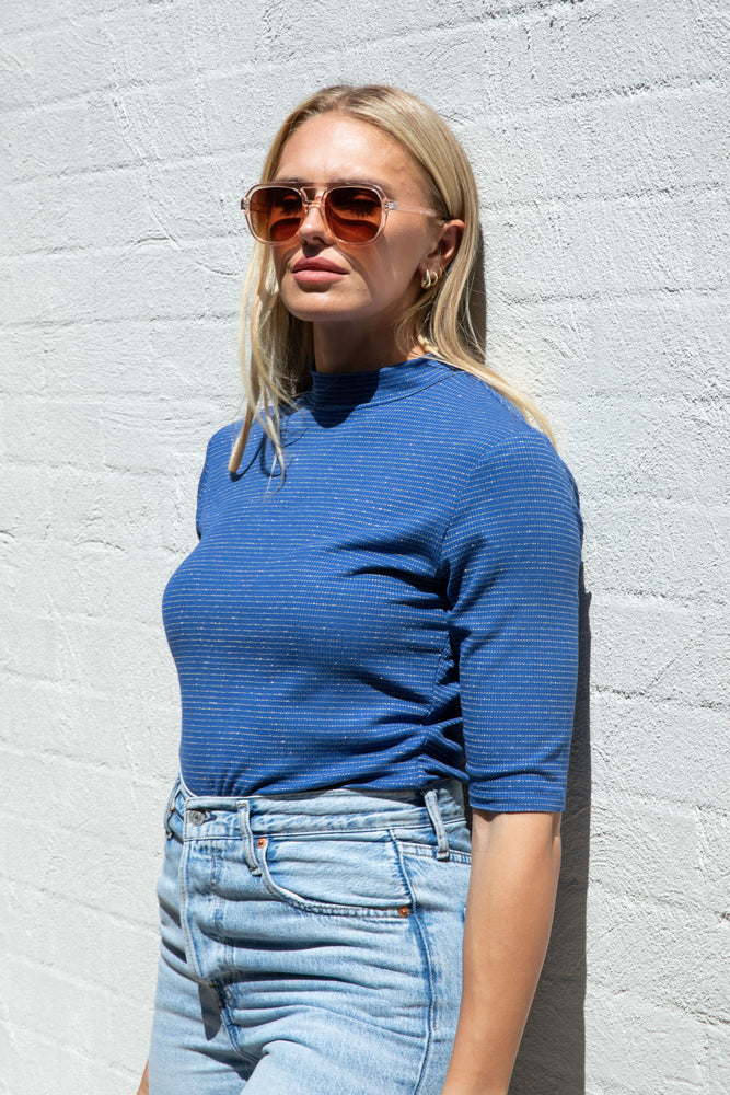 
                  
                    Blue with Gold Stripe Mock Neck Top
                  
                