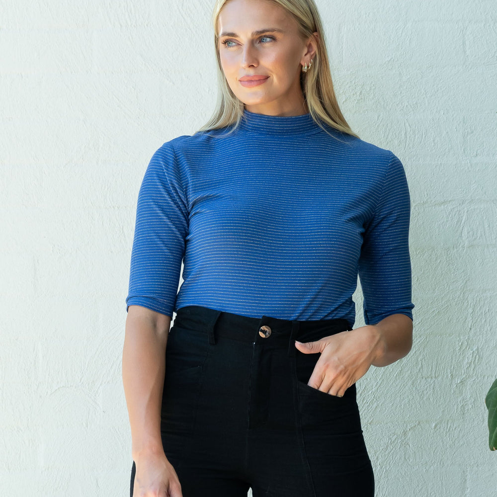 
                      
                        Blue with Gold Stripe Mock Neck Top
                      
                    