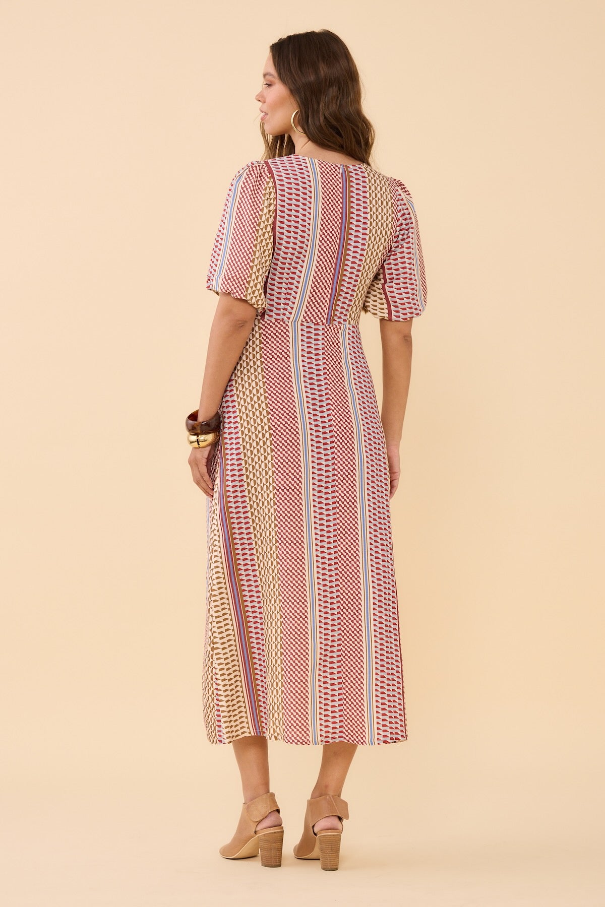 Woman wearing Frock Me Out Resort Mod Shapeshifter Dress standing facing her back to the camera